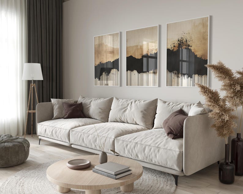 Minimalist abstract triptych featuring earthy beige and black tones with textured brushstrokes and dripping ink effect, evoking Japandi style.