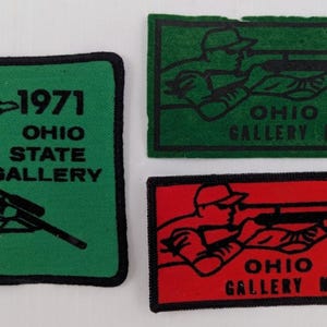 May include: Three vintage patches. One green patch with black text and a figure aiming a rifle, and the text "1971 OHIO STATE GALLERY". Two rectangular patches with a figure aiming a rifle, and the text "OHIO STATE GALLERY MATCHES" with the years 1972 and 1974.