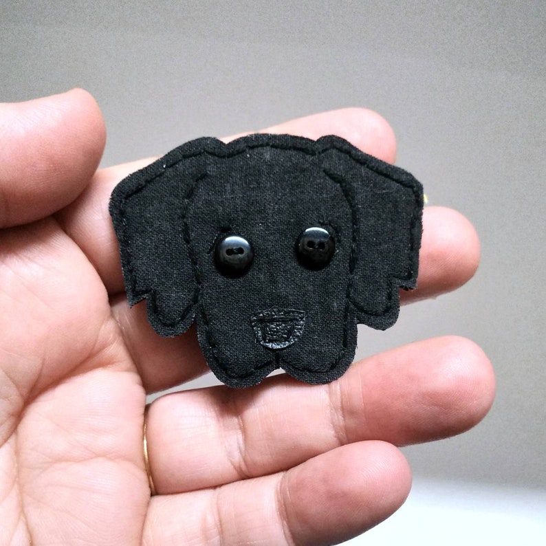 May include: Black felt dog applique with black button eyes.