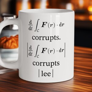 May include: White ceramic mug with black text. The mug features mathematical symbols and the words "corrupts" and "lee". The mug has a curved handle and is likely used for hot beverages.