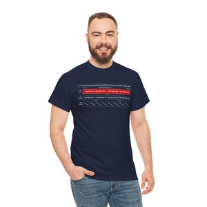 May include: A navy blue t-shirt featuring a white and red graphic print of a network subnetting chart. The chart displays IP address ranges and binary subnet masks, including text that reads A VISUAL IP RANGE BAR NETWORK RANGE EXAMPLES APPROACH RECURSIVE SUBNETTING.