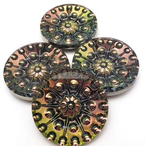 May include: Four iridescent green, brown, and black glass buttons with a raised, circular design.
