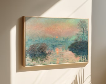 May include: A framed painting depicting a hazy, pastel-colored landscape with a river, trees, and a small town in the distance. The sun is setting over the town, casting a warm glow on the water.