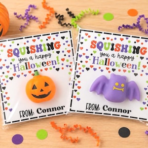 May include: Two clear plastic favor bags containing Halloween-themed squishy toys. One bag holds an orange pumpkin, the other a purple bat. Each card features the text SQUISHING you a happy Halloween and FROM: Connor with colorful heart confetti.