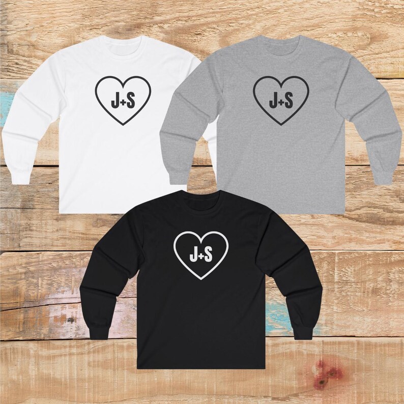 May include: Three long-sleeved shirts with a heart design and the text "J+S" in white. The shirts are white, grey, and black.