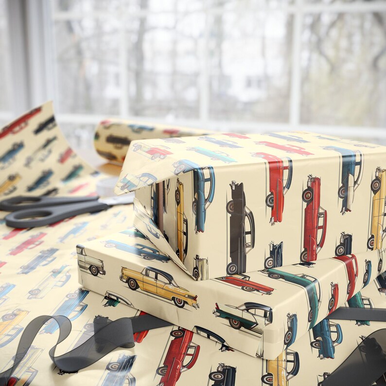 May include: A stack of gift wrap featuring a vintage car pattern. The wrapping paper is cream colored with a repeating pattern of colorful cars. The cars are in various shades of blue, red, yellow, and green.