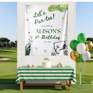 May include: A white rectangular backdrop featuring golf-themed illustrations, the text Let's Par-tee! WELCOME TO ALISON'S 5th Birthday JULY, 2026, a golf cart, and clubs. Below is a table with a green and white striped tablecloth and a white cake.