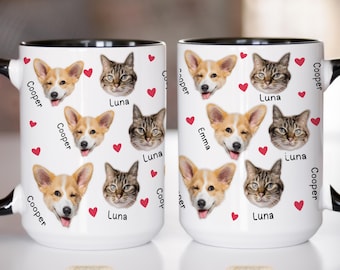 May include: White ceramic mug with black trim and handle, featuring a repeating pattern of a corgi, a tabby cat, and red hearts. The names "Cooper", "Luna", and "Emma" are also printed on the mug.