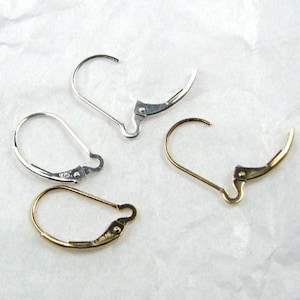 May include: Two pairs of earring hooks, one pair is gold and the other is silver.