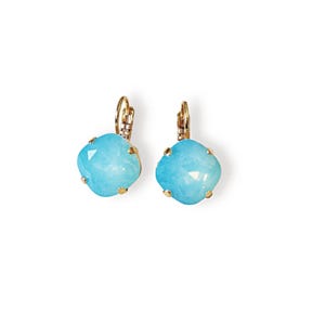 May include: A pair of lever-back earrings with gold-colored metal and light blue, square-shaped stones. The stones have a faceted appearance, catching the light. The earrings are set against a white background.