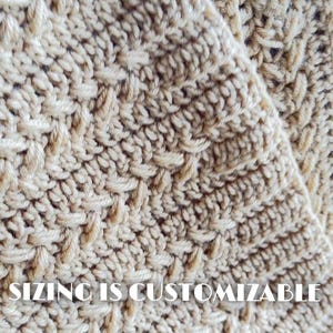 May include: A beige crochet fabric featuring a textured, repeating stitch pattern with diagonal lines and raised loops. The surface displays a consistent, dense weave throughout the material. The text SIZING IS CUSTOMIZABLE is visible.