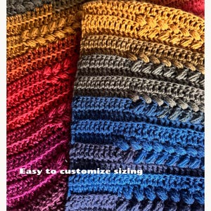 May include: Close-up of a colorful, crocheted textile with a gradient of colors from red to blue. The text "Easy to customize sizing" is visible. The crochet work features a textured, raised stitch pattern, creating a visually appealing and tactile surface.