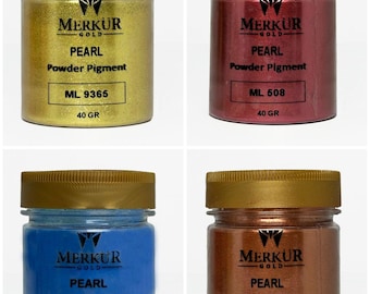 May include: Four jars of Merkur Gold Pearl Powder Pigment in gold, red, blue, and bronze. Each jar has a gold lid and a label with the product name, color code, and weight of 40 grams. The text "PEARL Powder Pigment" is visible on each jar.