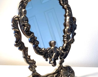 Vintage Ornate Silver Plated Vanity Swivel Tilt Table Top Mirror With Cherub and Shell Motif in Art Nouveau or Baroque Revival Style Sturdy