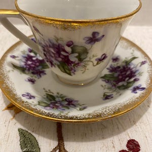 Vintage tea cup and saucer, violets with gold trim