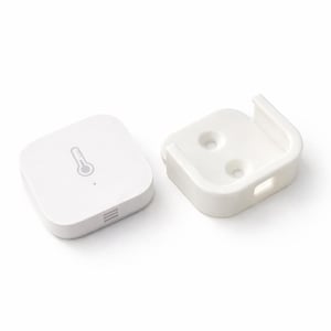 May include: A white, square smart home temperature sensor with a thermometer icon and a matching white mounting bracket. The sensor has a small LED indicator and a series of horizontal lines at the bottom. The bracket has two holes and a rectangular opening.