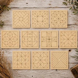 May include: A set of ten square light-colored wooden coasters, each featuring a unique dark brown laser-engraved geometric pattern. The designs include various arrangements of lines, triangles, and squares, creating distinct quilt-like motifs.