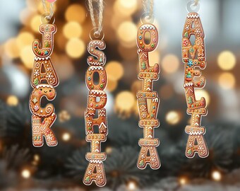 May include: Four gingerbread-style name ornaments spelling out "JACK", "SOPHIA", "OLIVIA", and "ADELA". Each ornament is brown with white icing details and colorful sprinkles, hanging from twine. Festive holiday decor.