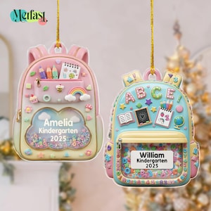 May include: Two personalized backpack ornaments. One is pink and the other is blue. The pink backpack has a cloud-shaped window with the name "Amelia Kindergarten 2025". The blue backpack has the name "William Kindergarten 2025". Both have colorful details.
