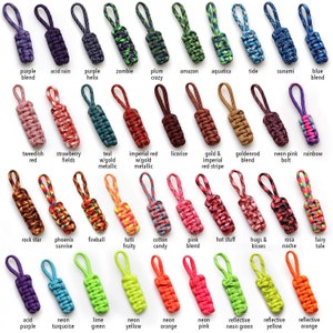 May include: A collection of 30 colorful paracord keychains with various patterns and designs. The keychains are made with different colors of paracord, including red, blue, green, yellow, orange, purple, pink, and black. Each keychain has a unique name, such as "Tweedish Red", "Fireball", "Neon Pink Bolt", and "Acid Purple".