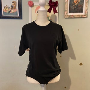 Vintage black short sleeve leotard with embroidered chest emblem • by Lizwear