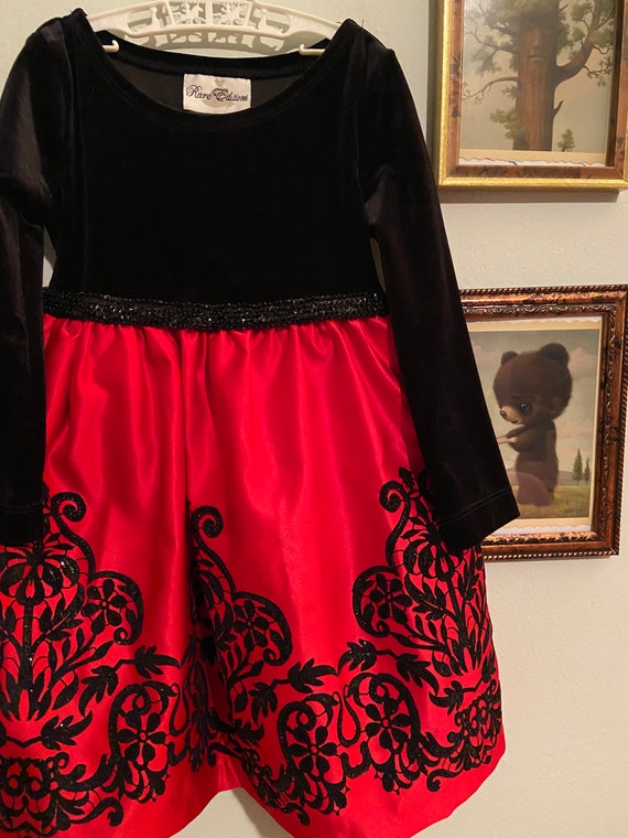 Vintage child’s red and black dress with velour bo