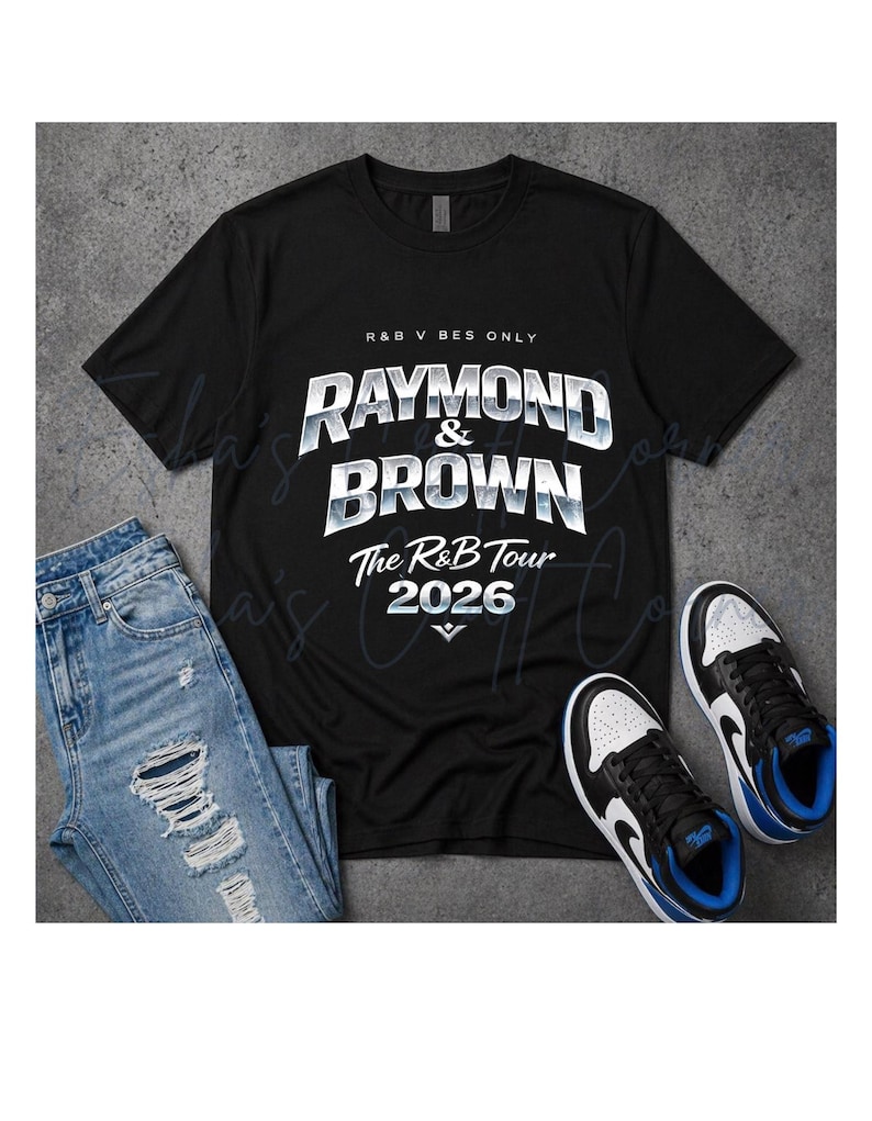 May include: Black t-shirt with the text "RAYMOND & BROWN The R&B Tour 2026" in white and silver lettering. The shirt is paired with distressed blue jeans and black and white sneakers with blue accents.
