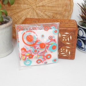 May include: Two red and white fabric bow ties with a blue and white button pattern. The bow ties are packaged in a clear plastic bag with a white card that says "Avon Button Shoes".