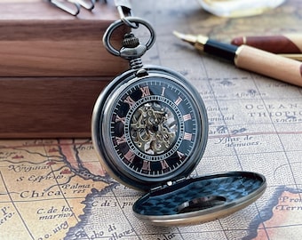 May include: A black and silver pocket watch with a skeleton dial, showcasing the inner workings. The watch has Roman numerals and is open, revealing a detailed mechanism. It rests on a vintage map, with a wooden box in the background.