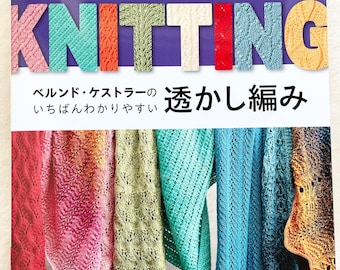 May include: A book cover with the title "LACE KNITTING" in colorful, textured letters. Below the title are Japanese characters. The cover features images of colorful knitted lace scarves in various patterns and colors.