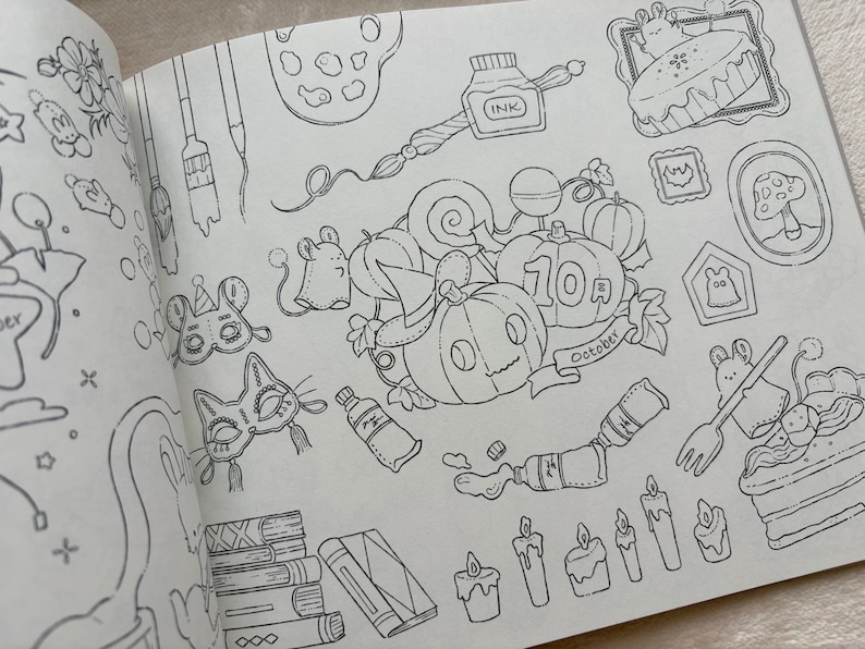 May include: A black and white illustration from a colouring book featuring Halloween-themed objects. The image includes pumpkins, candles, masks, and a cake. The word "October" is on a banner near the pumpkins.