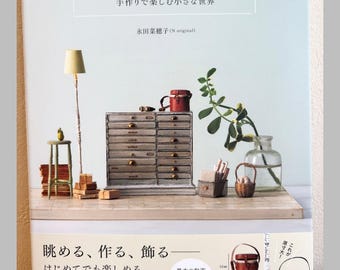 May include: A craft book titled "Adult Miniature Interior" featuring a cover image of miniature furniture, including a tall lamp, a multi-drawer cabinet, books, a glass vase with a plant, and baskets. A ruler shows 10mm and 7mm scale references.