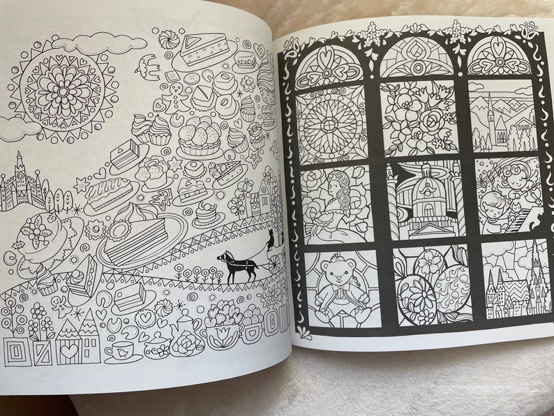 May include: A black and white coloring book page with a variety of images, including a castle, a carousel, a teacup, a cake, and a window with stained glass. The page is divided into two sections, with the left side featuring a more whimsical design and the right side featuring a more traditional design.