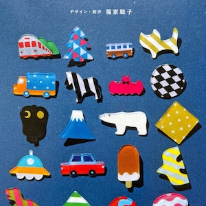 May include: A collection of colorful plastic charms, including a train, a Christmas tree, a bus, a cat, a truck, a zebra, a bat, a checkered circle, a crescent moon, a mountain, a polar bear, a polka dot square, a UFO, a car, an ice cream cone, a striped fish, a dinosaur, a diamond, a planet, and an octopus. The charms are all made of clear plastic with different colored patterns and designs. The charms are arranged in a grid pattern on a blue background. The text "Pomadour's Craft Cafe" is at the bottom of the image.