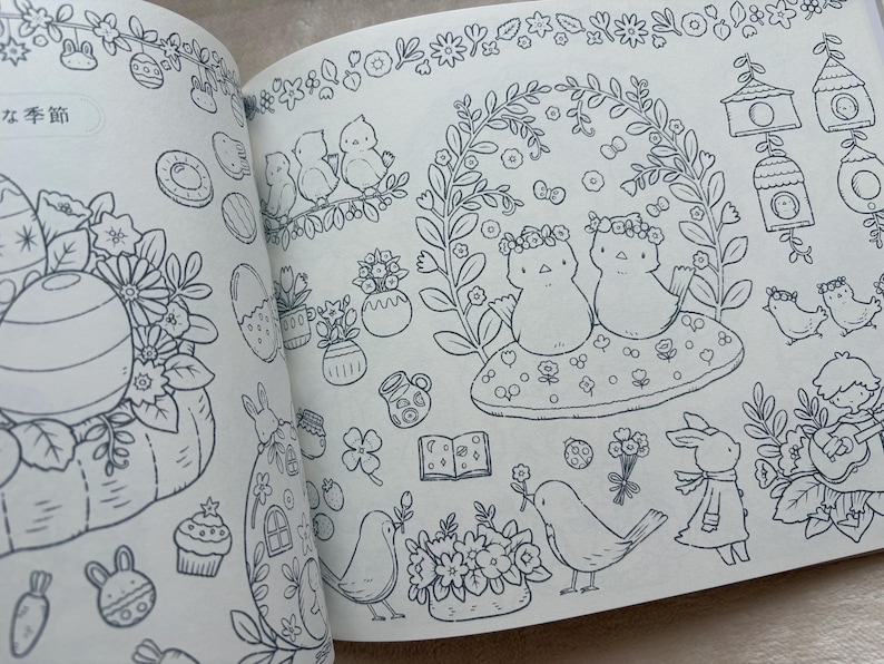 May include: A black and white illustration of a coloring book page with spring-themed drawings. The page features birds, bunnies, flowers, birdhouses, and other seasonal elements. The drawings are detailed and whimsical.