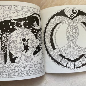May include: A black and white coloring book page with two intricate designs. The left side features a whimsical scene with a bird, a frog, and a castle. The right side features a peace sign with a floral design.