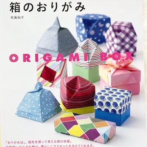 May include: A book titled "Origami Box" with the subtitle "Fingertip Fun: Tiny Boxes for Tiny Treasures" by Chizuko Fuse. The cover features colorful origami boxes in various patterns and designs.