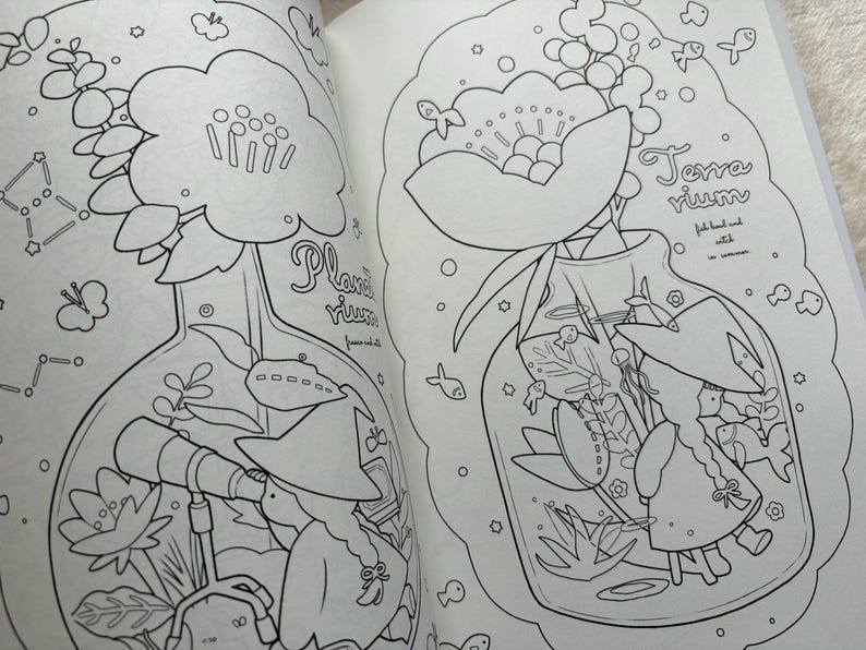 May include: Black and white line art of two illustrations in a coloring book. One shows a flower in a flask with the text "Plantarium". The other shows a terrarium with the text "Terrarium".