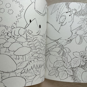 May include: Black and white illustration of a coloring book spread featuring woodland scenes. One page shows a pig-like character and mushrooms. The other page depicts a squirrel reaching for a nut, with a bag of nuts below.