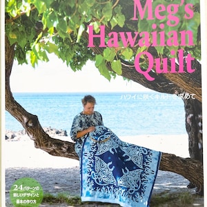 May include: A book cover featuring a woman working on a blue and white quilt with a Hawaiian theme. The title is "Meg's Hawaiian Quilt" in English, with additional Japanese text. The background shows a beach and ocean scene.