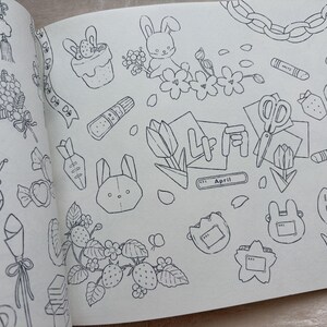 May include: A detailed black and white illustration featuring various spring-themed doodles. The drawings include bunnies, flowers, strawberries, carrots, scissors, and the word "April". The overall theme is a whimsical, hand-drawn style.