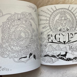 May include: A black and white coloring book page with a detailed illustration of a rose on the left side and an illustration of a stylized eagle with the word "EGYPT" below it on the right side.
