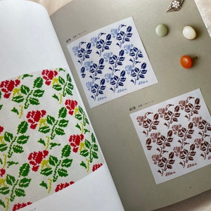 May include: A book with three different floral patterns. The patterns are red and green, blue and white, and brown and white. The book has the numbers 68 and 69 on the pages.