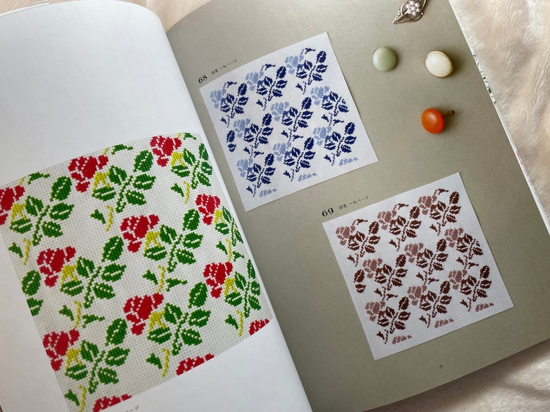 May include: A book with three different floral patterns. The patterns are red and green, blue and white, and brown and white. The book has the numbers 68 and 69 on the pages.