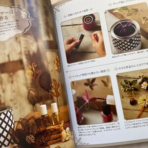 May include: A book with instructions on how to make dip flowers. The book features photos of various flowers made with the dip technique. The text on the page reads "Dip flowers are made this way".
