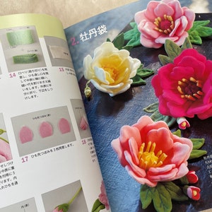 May include: A book with instructions on how to make felt flowers. The book shows different steps for making the flowers, including how to cut the felt, sew the pieces together, and add details. The book also includes a picture of a finished felt flower.