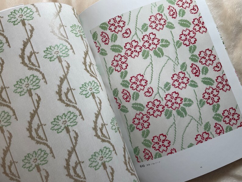 May include: Two pages from a book showing cross-stitch patterns. The left page shows a pattern of green and brown flowers with vines. The right page shows a pattern of red flowers with green leaves and vines. The page number is 66 and the text "花柄" is visible.