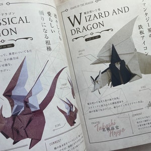 May include: A book open to a page showing two origami dragon designs. The first design is a classic dragon with a cute form. The second design is a wizard and dragon with a black wizard holding a staff and a white dragon. The text on the page reads "Classical Dragon" and "Wizard and Dragon".