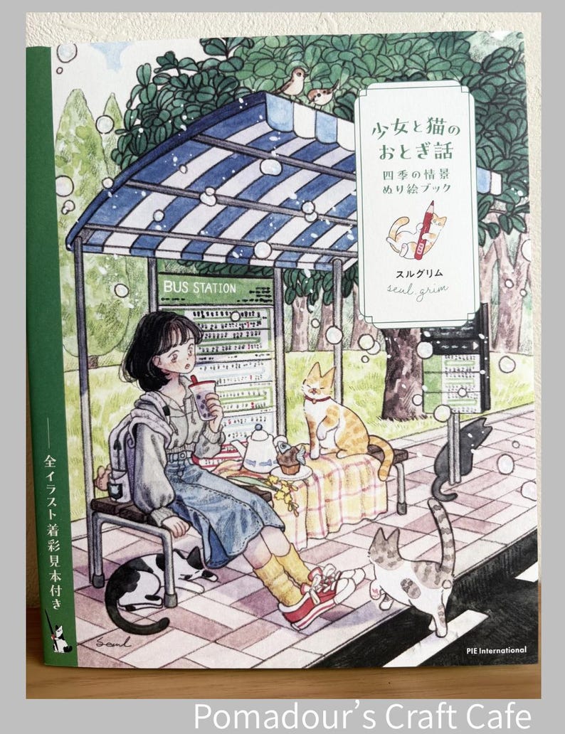 May include: A colouring book cover featuring a watercolour illustration of a person sitting at a bus station with several cats. The text reads 少女と猫のおとぎ話, 四季の情景, ぬり絵ブック, and seal grim. The scene includes a blue and white striped roof, trees, and a bus schedule sign.
