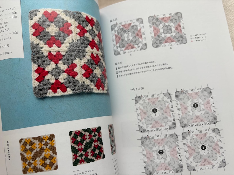 Puede incluir: Un cuadrado de ganchillo con un patr&oacute;n geom&eacute;trico rojo, gris y blanco se muestra en un libro abierto. La p&aacute;gina tambi&eacute;n muestra diagramas y ejemplos de otros patrones de ganchillo. El cuadrado es un primer plano, mostrando la textura y los colores.